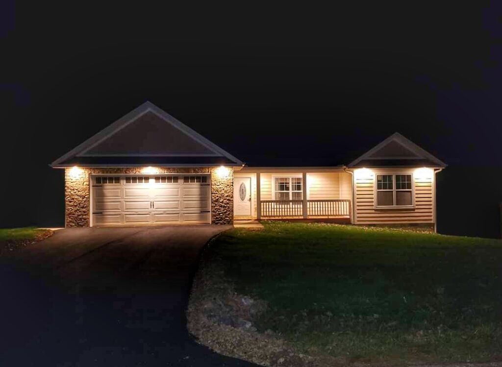 beautifully lit home exterior at night, showcasing elegant landscaping and ambient lighting that highlights architectural features